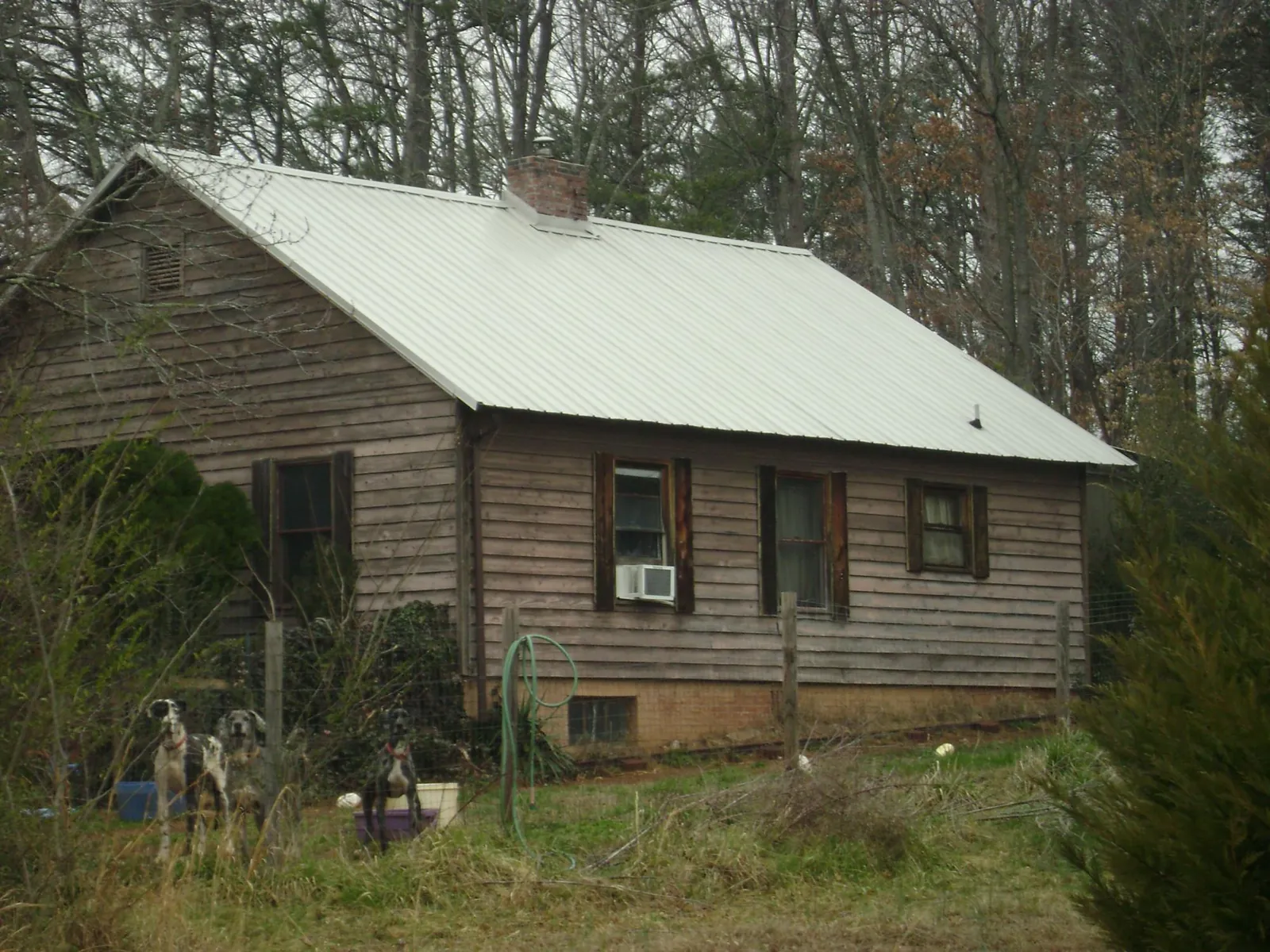 White metal roof on an old wood sided farmhouse, from a Metal Roof Installation job in Beardsley